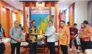 Penjagub Gorontalo Menyerahkan Cendera Mata Kepada Gubernur Sulawesi Tengah