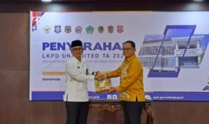 Bupati Gorontalo Utara Thariq Modanggu saat menyerahkan Laporan Keuangan Pemerintah Daerah Gorontalo Utara kepada Kepala BPK Perwakilan Provinsi Gorontalo