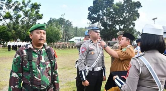 Penjabup Boalemo Hendriwan saat menyematkan pita secara simbolis kepada perwakilan petugas Operasi Ketupat Otanaha 2023.
