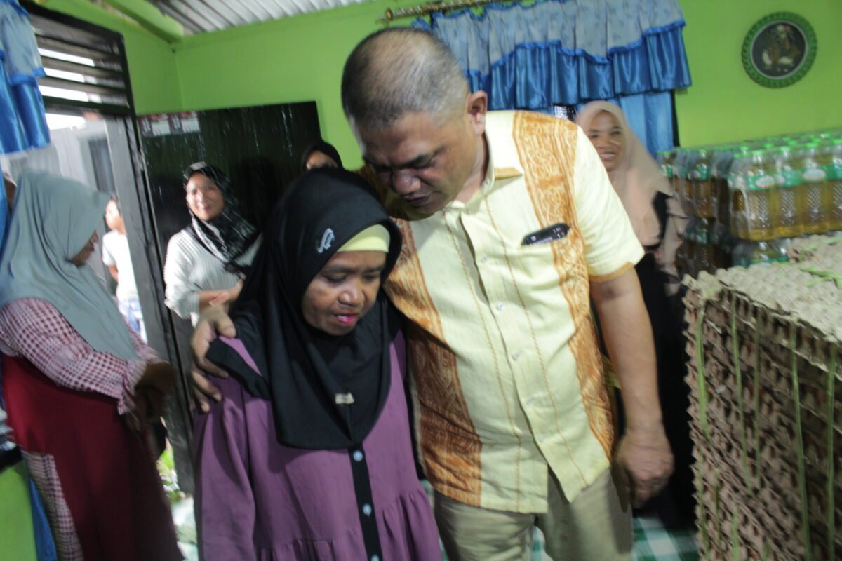 Ketua DPRD Pohuwato Nasir Giasi merangkul seorang ibu yang menjadi tulang punggung keluarga
